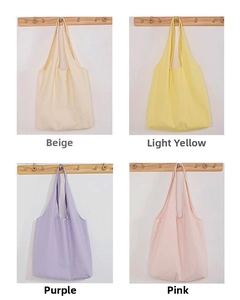 Detailed grid view showing large canvas tote bags in beige, yellow, purple, and pink colors