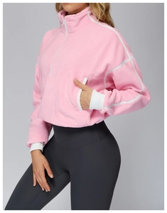 Close-up of pink fleece sweatshirt showing half-zip detail and soft textured fabric