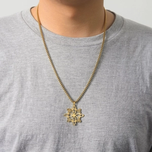 Golden stainless steel Viking triskelion pendant necklace shown on a male model