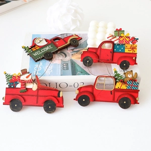 Close-up of four red wooden Christmas truck ornaments with Santa and snowman motifs