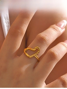 Detail of a vintage golden hammered heart ring with a unique textured metal finish