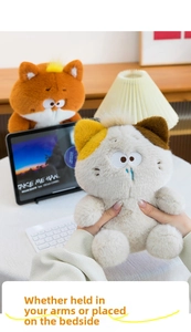 Detail of cute plush cat doll with blue tear makeup on cozy office desk setup