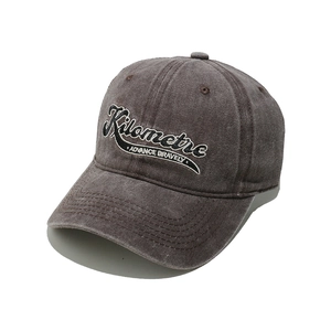Detail of vintage washed baseball cap with Kilometre and Advance Bravely embroidery