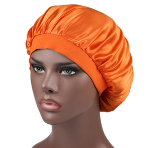 Detail of orange silky satin bonnet with wide elastic band on a mannequin head