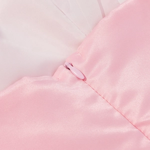 Macro shot of pink satin fabric texture and high-quality invisible zipper on the dress