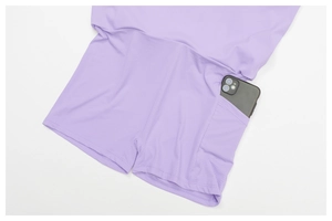 Detail view of purple sports skort showing a side pocket holding a smartphone