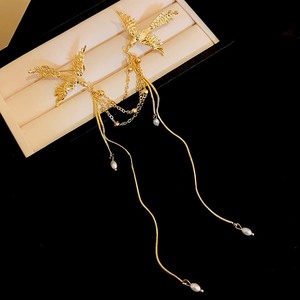 Vintage gold phoenix brooch set with white pearls and connecting chain on jewelry box