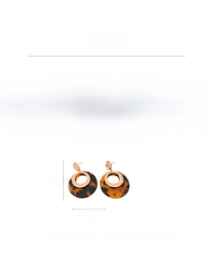 Detail view of 18K gold plated resin earrings with tortoise pattern and copper specs