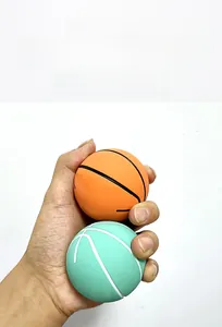 Detailed view of mini bouncy basketballs in orange and mint green for stress relief