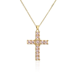 Macro view of gold-plated cross pendant featuring pink square-cut zircon stones