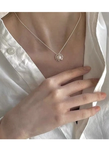Elegant S925 sterling silver necklace with a minimalist pearl pendant on white shirt