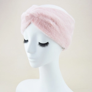 Dettaglio fascia di peluche rosa con texture in ecopelliccia e design a nodo incrociato