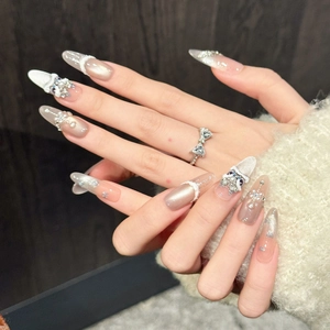Champagne cat-eye press-on nails with 3D cat charms, pearls, and crystals on almond shape