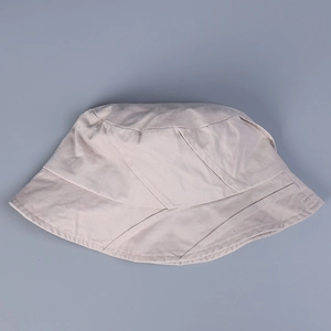 Foldable beige washed cotton bucket hat with asymmetrical diagonal stitching for women