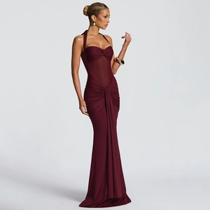 Detail of burgundy ruched maxi dress featuring a backless halter neck and mesh patchwork