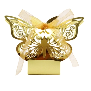Detailed laser-cut gold butterfly favor box with elegant gold ribbon on white background