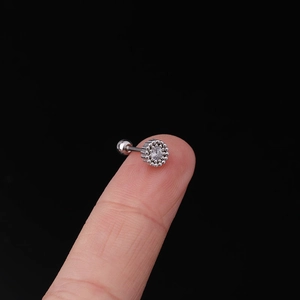 Macro shot of 20G stainless steel helix earring with white zircon inlay and bead edge