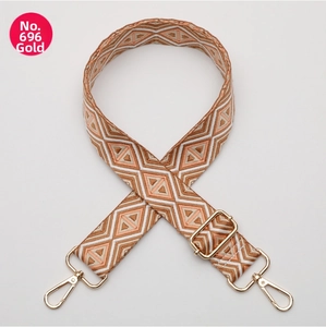 Detail of adjustable woven purse strap featuring geometric diamond patterns and gold hooks