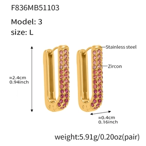 Detailed view of U-shaped gold earrings featuring gradient pink zircon and stainless steel
