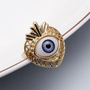 Macro view of adjustable gold evil eye ring with purple enamel and micro pavé detailing