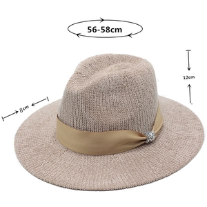 Detail of beige knit fedora with gold ribbon, rhinestone buckle and size specs
