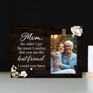 Detail of wooden Mother's Day photo frame with engraved message and rustic metal clip