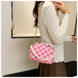 Detail of pink plaid pattern clasp bag with elegant pearl strap and gold chain