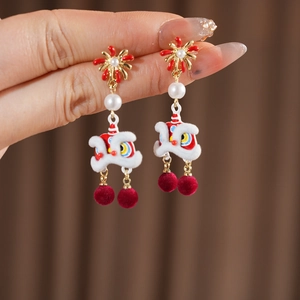 Detail of Chinese lion earrings with red flocking balls and white pearl accents