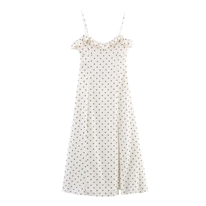 White midi dress with brown polka dots featuring spaghetti straps and side slit detail