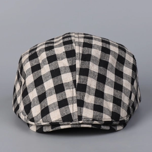 Gros plan sur la casquette plate à carreaux noir et blanc montrant la texture en lin