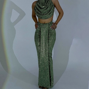 Detail view of sparkly green two-piece set featuring cowl neck top and maxi skirt