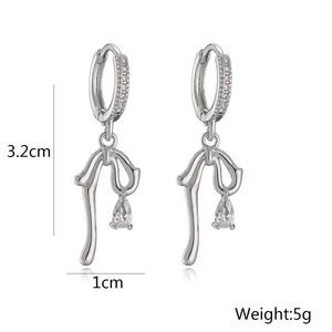 Detail view of 18K gold plated bow earrings with zircon stones and size dimensions