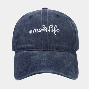 Detail of #momlife print on washed navy denim baseball cap with heart graphic