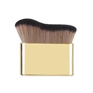 Close-up of wavy dual-tone bristles and golden metallic handle of the foundation brush