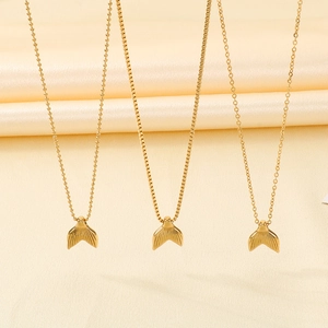 Golden fishtail necklaces with three chain styles on a luxury satin background