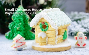 Detailed close-up of DIY 3D Christmas gingerbread house cookies with royal icing decoration