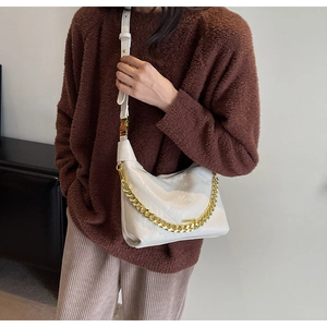 Close-up of white quilted PU leather shoulder bag featuring a gold chain strap detail