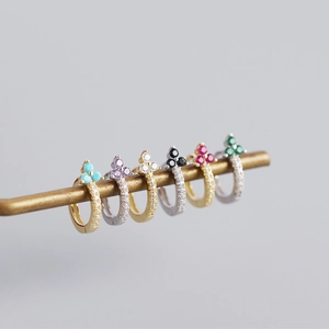 Detailed close-up of S925 silver flower earrings with colorful zircon stones on a brass rod