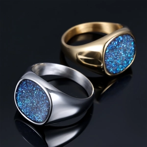 Men's minimalist stainless steel signet ring with blue crystal inlay on black background