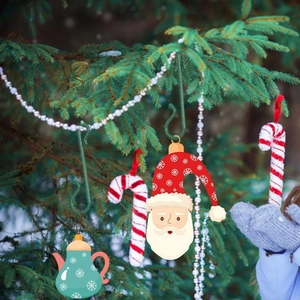 Set of green S-shaped hooks for hanging Christmas tree ornaments and festive decorations