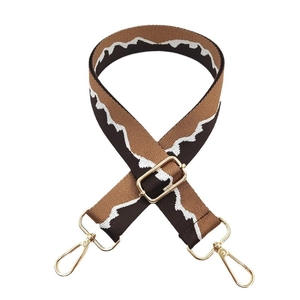 Adjustable brown jacquard woven bag strap with white wave patterns and gold metal clips