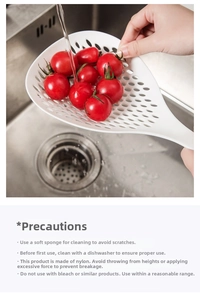White nylon slotted spoon straining cherry tomatoes in a kitchen sink setting
