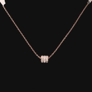Macro shot of rose gold titanium necklace featuring a triple-row pavé diamond pendant