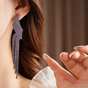 Detail view of purple crystal tassel earrings with a tiered waterfall drop design