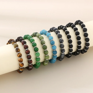 Detailed view of elastic stone bead bracelets with lava rocks and metal spacers