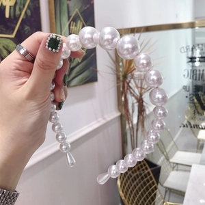 Detail of Korean style pearl headband with varied size white pearls and rhinestones