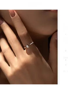 Detail of S925 sterling silver tear-drop ring with pavé diamonds on a model's hand