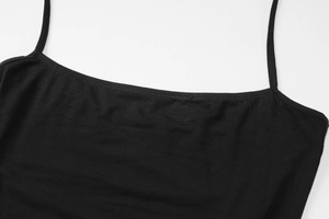 Detail shot of the black camisole showing fine ribbed fabric and seamless shoulder straps