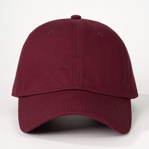 Detailed close-up of dark red cotton baseball cap with six-panel construction and curved brim
