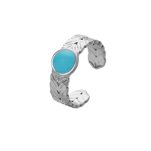 Detailed macro view of silver open ring with turquoise stone and carved leaf texture